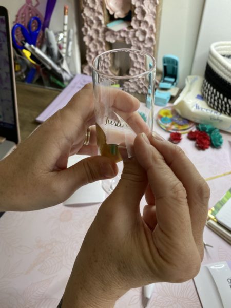 Person adding adhesive foil to champagne glasses