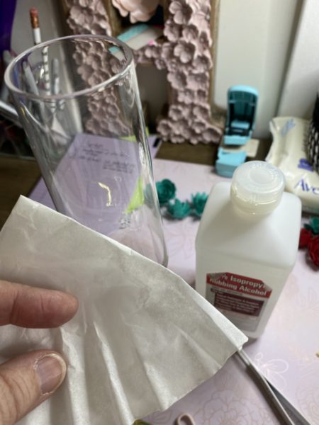 Person cleaning a glass with alcohol & coffee filter